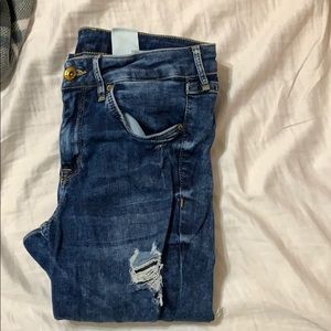 Dark wash skinny jeans with holes